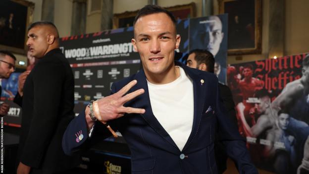 Josh Warrington holds up three fingers to the camera