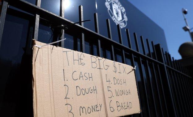 A protest sign outside Manchester United's Old Trafford ground