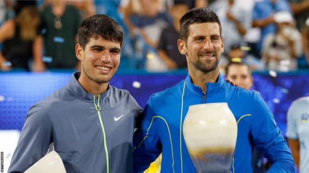 Carlos Alcaraz and Novak Djokovic airs  with their trophies aft  the Cincinnati final