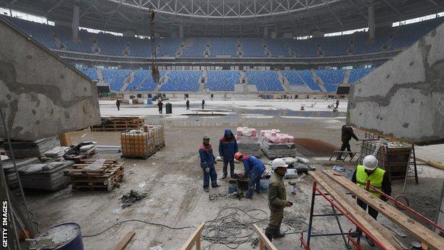 Workers help construct the Krestovksy Stadium