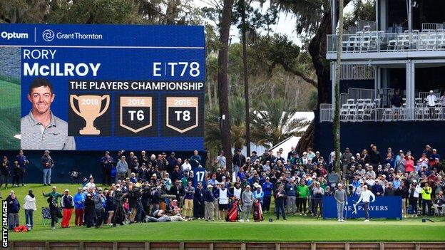 Rory McIlroy, Justin Thomas, Collin Morikawa and their caddies on the 17th tee at TPC Sawgrass