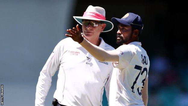 India fast bowler Mohammed Siraj (right) points to a section of the crowd while talking to umpire Paul Reiffel (left) after receiving alleged abuse during day four of the third Test against Australia