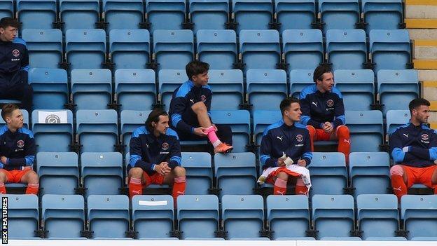 Substitutes sitting in the stands