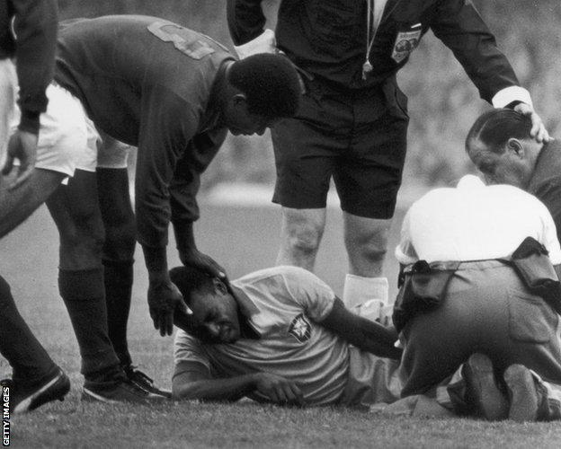 Pele is comforted by Portugal's Eusebio successful  1966