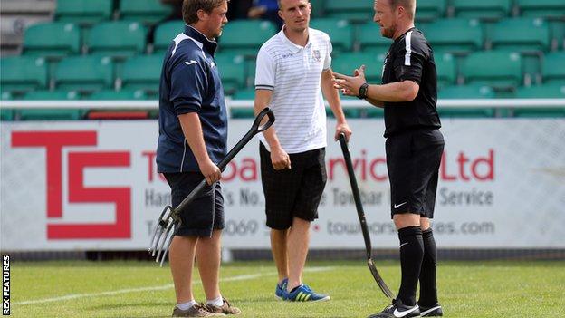 Referee David Rock speaks with Eastleigh ground staff before the match against Dagenham