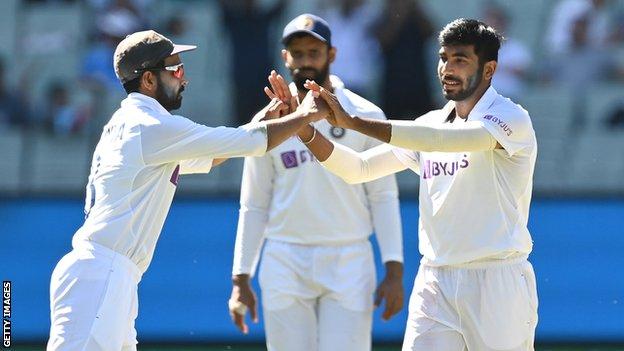 India fast bowler Jasprit Bumrah celebrates with team-mates after taking a wicket on day one of the second Test against Australia