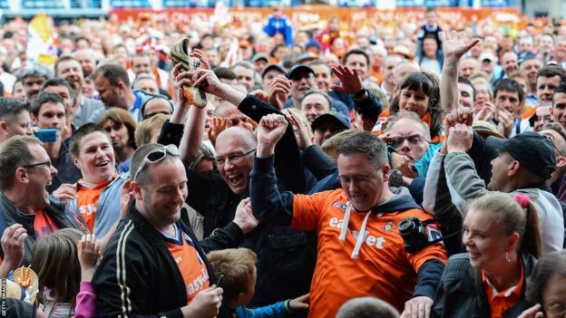 Luton Town fans on the pitch at Kenilworth Road after winning the Conference