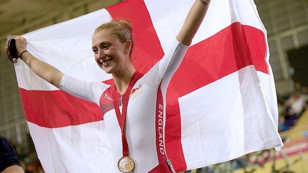 Laura Kenny holds up an England flag after winning gold at the 2014 Commonwealth Games