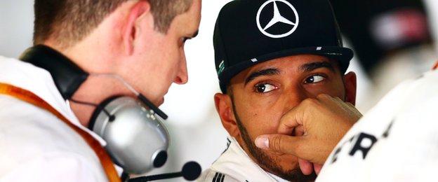 Lewis Hamilton chatting to engineer