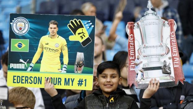 A Manchester City fan holds up a sign dedicated to Ederson during last month's 6-0 FA Cup quarter-final win over Burnley