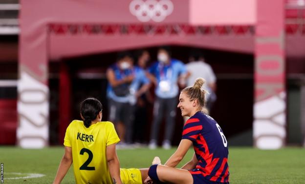 Sam Kerr and Kristie Mewis sit and chat on the pitch after their bronze medal match at the Tokyo Olympics of 2021