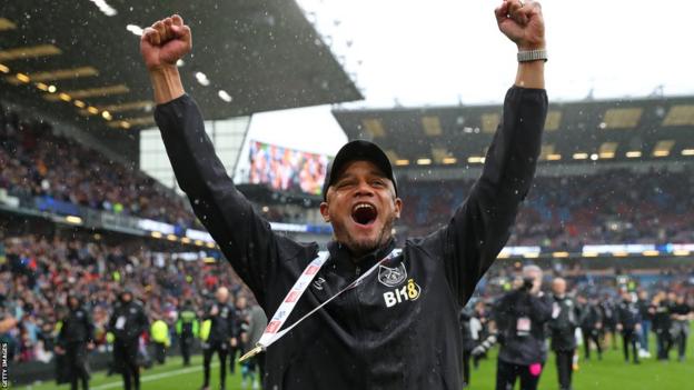 Vincent Kompany pumps his fists aloft in celebration after lifting the Championship trophy with Burnley