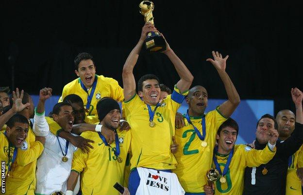 Lucio ergue o troféu da Copa das Confederações de 2009, com uma camiseta 'I Love Jesus' sobre o short