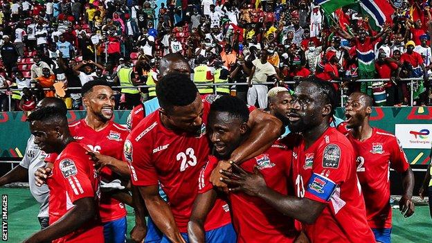 The Gambia's players celebrate victory over Tunisia