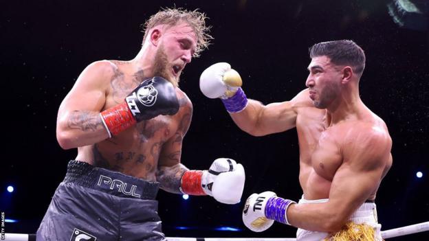 Tommy Fury throws a right hook at Jake Paul during their fight in Saudi Arabia