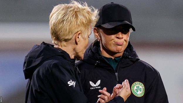 Vera Pauw and an injured Katie McCabe have a discussion at full-time