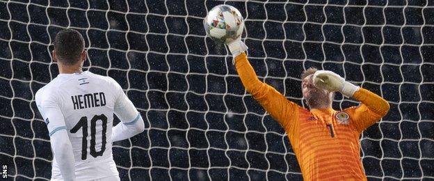 Tomer Hemed watches on as his shot is saved by Allan McGregor