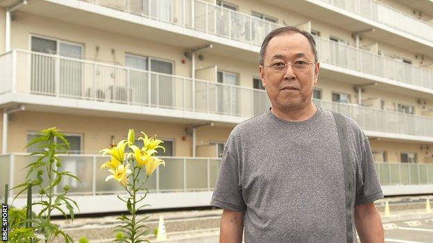 Mr Kumagami outside his new apartment