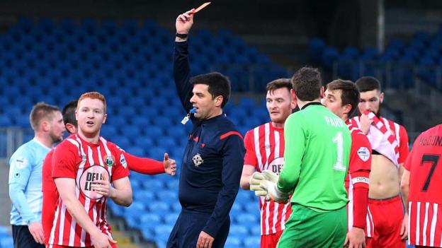 A look of amazement from Warrenpoint Town's Stephen Moan as referee Andrew Davey sends him off for handling on the line in the Showgrounds game against Ballymena United