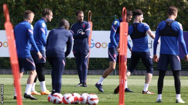 Gareth Southgate (centre) watches England training