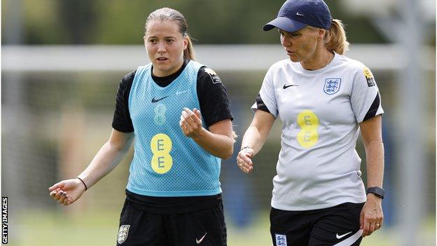 England boss Sarina Wiegman in discussion with Fran Kirby at training