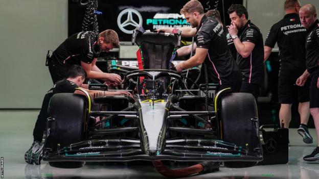 Mercedes mechanics work on Lewis Hamilton's car in Bahrain