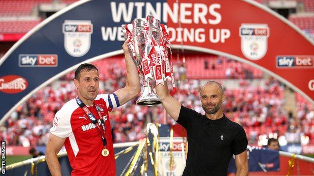 Rotherham's match-winner Richard Wood (left) lifts the play-off winners trophy with boss Paul Warne (right)