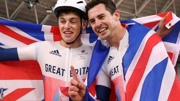 Fin Graham and Jaco van Gass celebrate winning gold and silver in the men's C3 3,000m individual pursuit at the Tokyo Paralympics