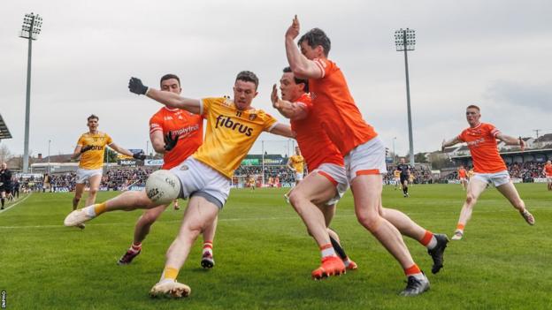 Antrim's centre half-forward Ruairi McCann is surrounded by Armagh's Aidan Forker, Aaron McKay and James Morgan