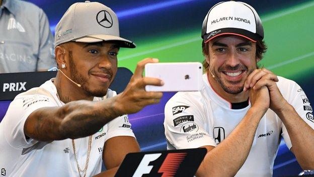 Lewis Hamilton, left, appeared relaxed in Belgium as he took a selfie on his phone with a smiling Fernando Alonso