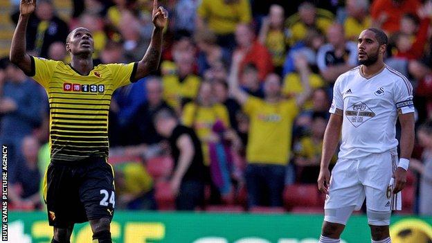 Ashley Williams looks on as Watford's Odion Ighalo celebrates