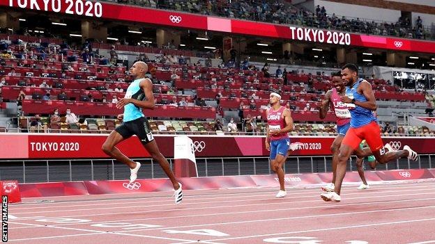 Steven Gardiner crosses the finish line
