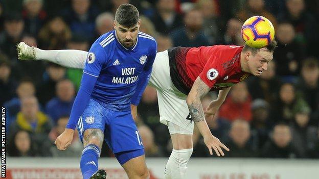 Cardiff City's Callum Paterson battles for the ball with Phil Jones of Manchester United