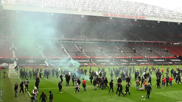 Manchester United fans invade the Old Trafford pitch