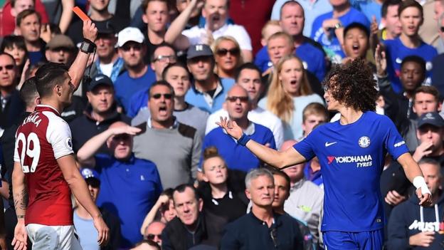 Chelsea's David Luiz protests to referee Michael Oliver as Granit Xhaka looks on