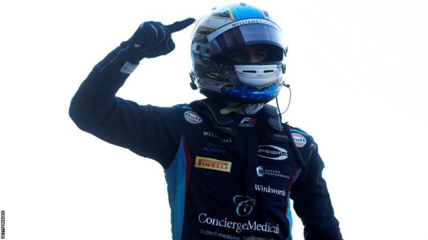 Zak O'Sullivan holds his finger up after winning the feature race in Budapest in July