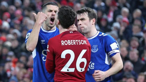 Everton's Conor Coady and Seamus Coleman clash with Liverpool's Andy Robertson during the Merseyside derby