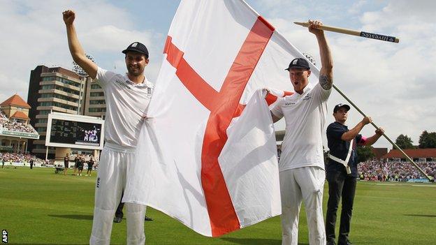 Mark Wood and Ben Stokes celebrate with an England flag