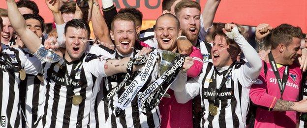 Dunfermline Athletic players celebrate with the Scottish League One trophy