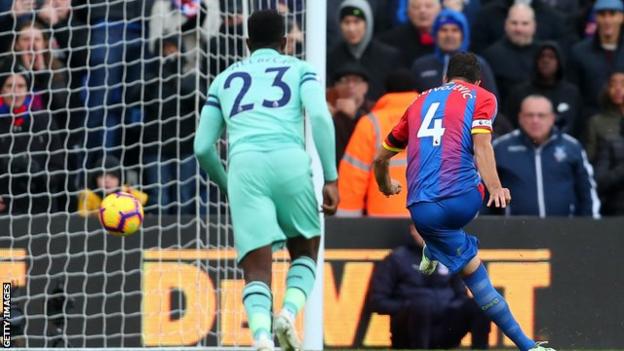 Luka Milivojevic scores from the penalty spot for Crystal Palace against Arsenal
