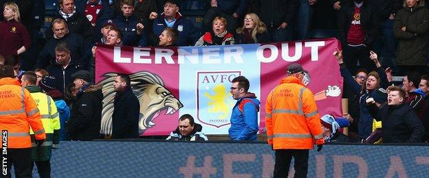 Aston Villa fans hold a banner at Wycombe declaring "Lerner Out"