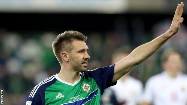 Gareth McAuley waves to Northern Ireland fans after the win over Norway in March