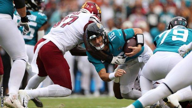 Efe Obada tackles Trevor Lawrence