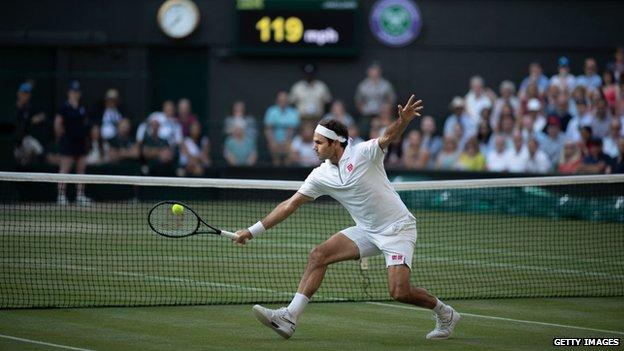 Roger Federer hitting a volley at Wimbledon