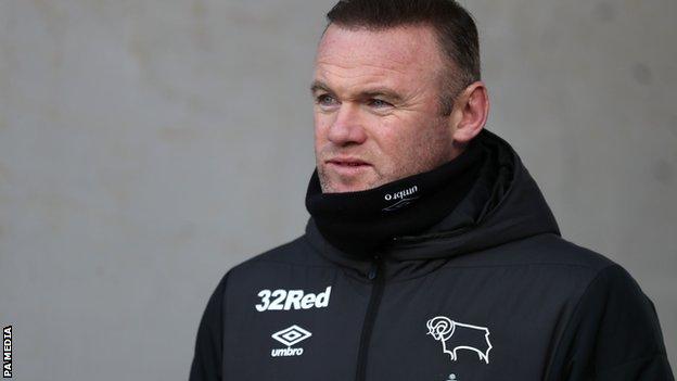 Wayne Rooney looks on