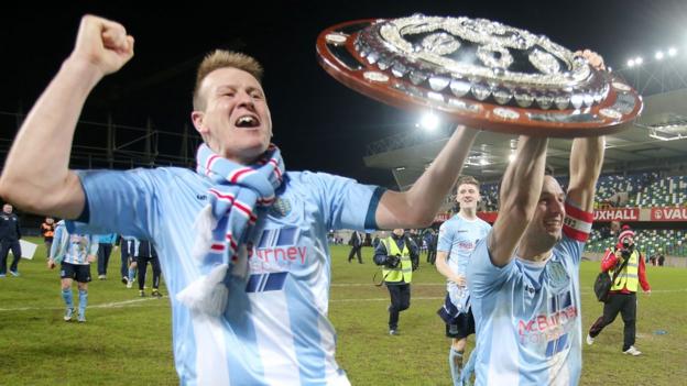 Scotsman Allan Jenkins and team captain Jim Ervin parade the Shield in front of delighted Ballymena supporters