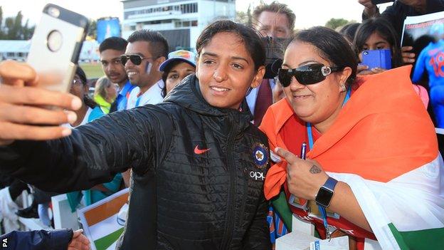 India's Harmanpreet Kaur takes a selfie with a fan after victory over Australia in the semi-finals