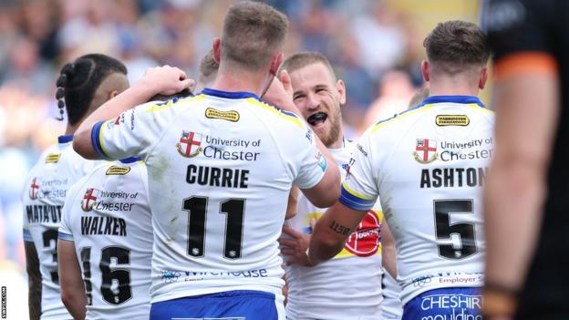 Warrington celebrate a try through Matt Dufty