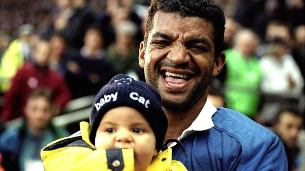 Emile Ntamack with six-month old Romain Ntamack after France's 1999 semi-final win over New Zealand
