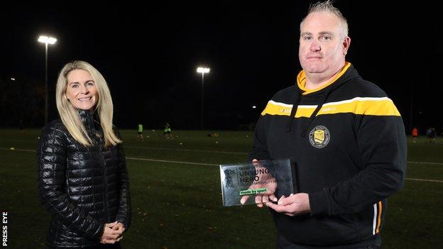 Brian McGuigan received the BBC Sport NI Unsung Hero award from Nicola McCarthy